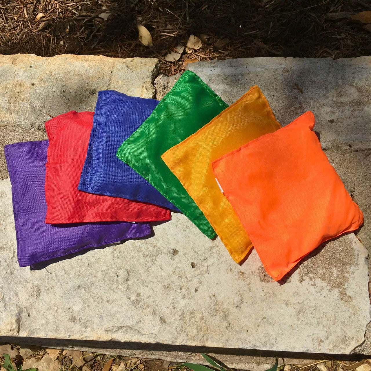 bean bags outside on a rock for a carnival game