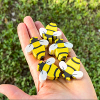 Thumbnail for bee erasers in a hand