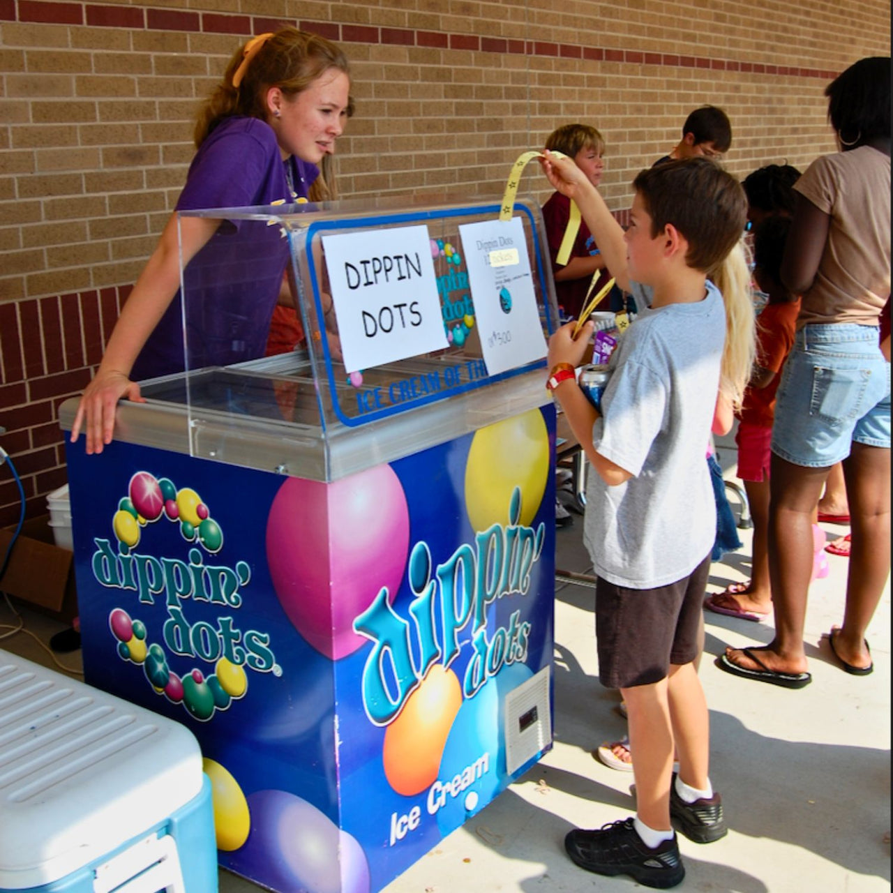 boy using yellow star tickets to buy treat at a school carnival