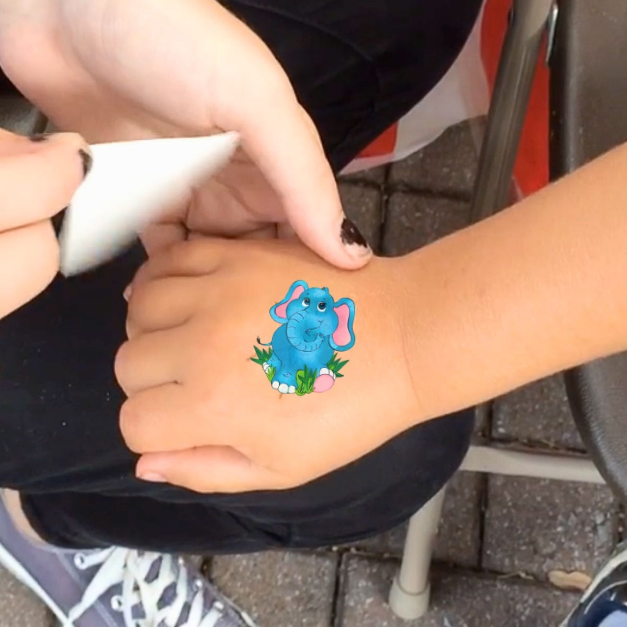 child hand with washable tattoo at a tattoo booth