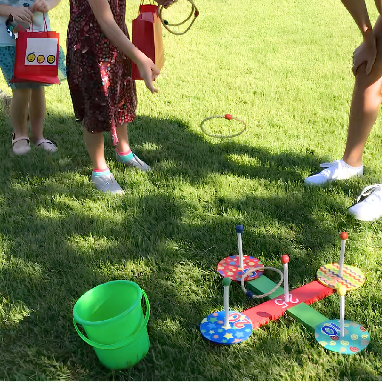 child playing wooden ring toss game outside in  the grass