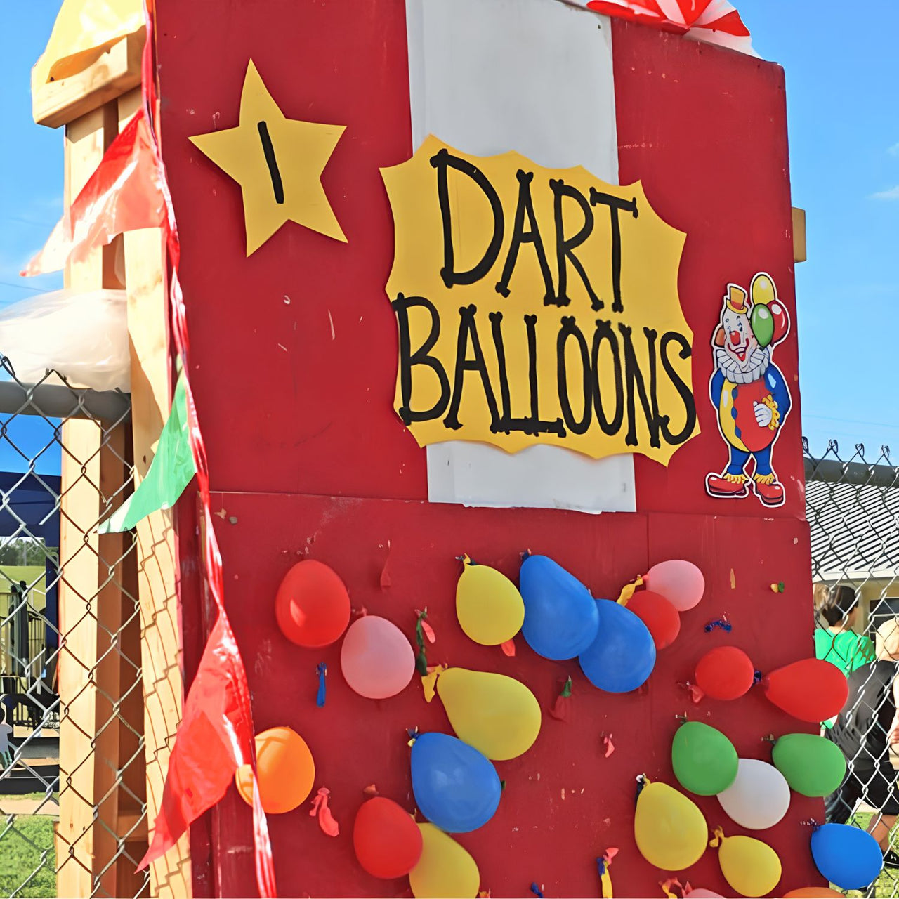 dart balloons game at a school carnival