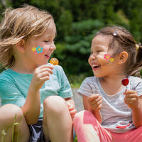 Thumbnail for girls with washable flower tattoos on their cheeks smiling