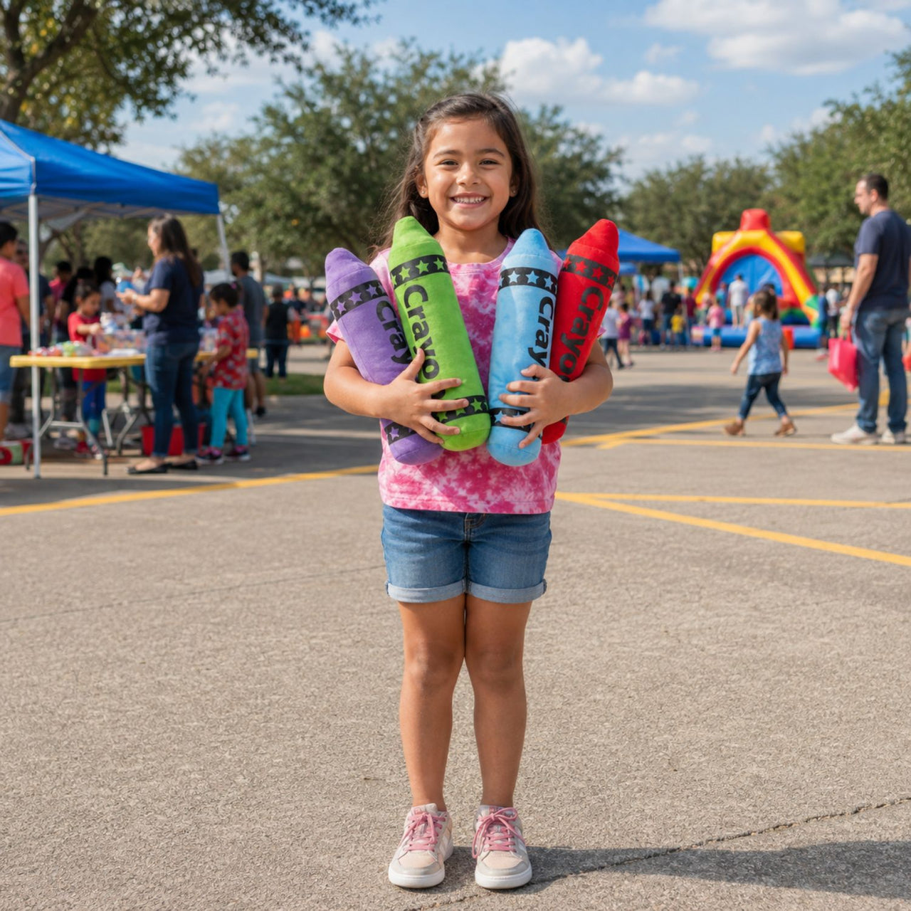 girl holding plush crayons at a carnival