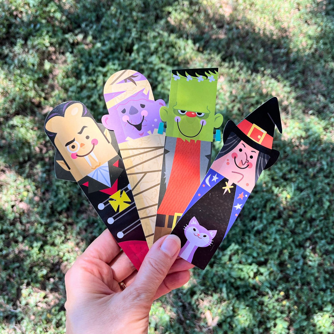 halloween bookmarks held in a hand outside