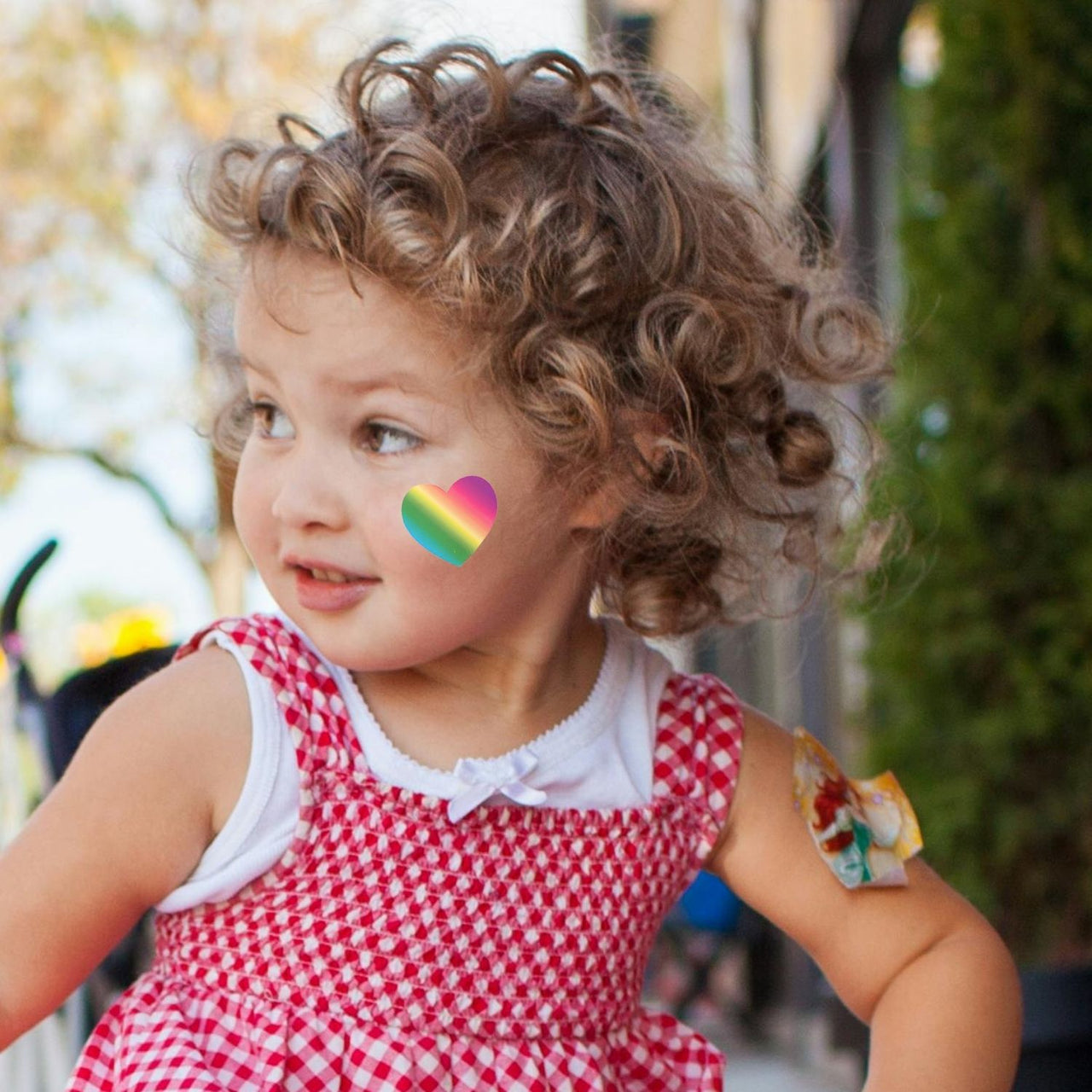 cute girl outside with heart temporary tattoo
