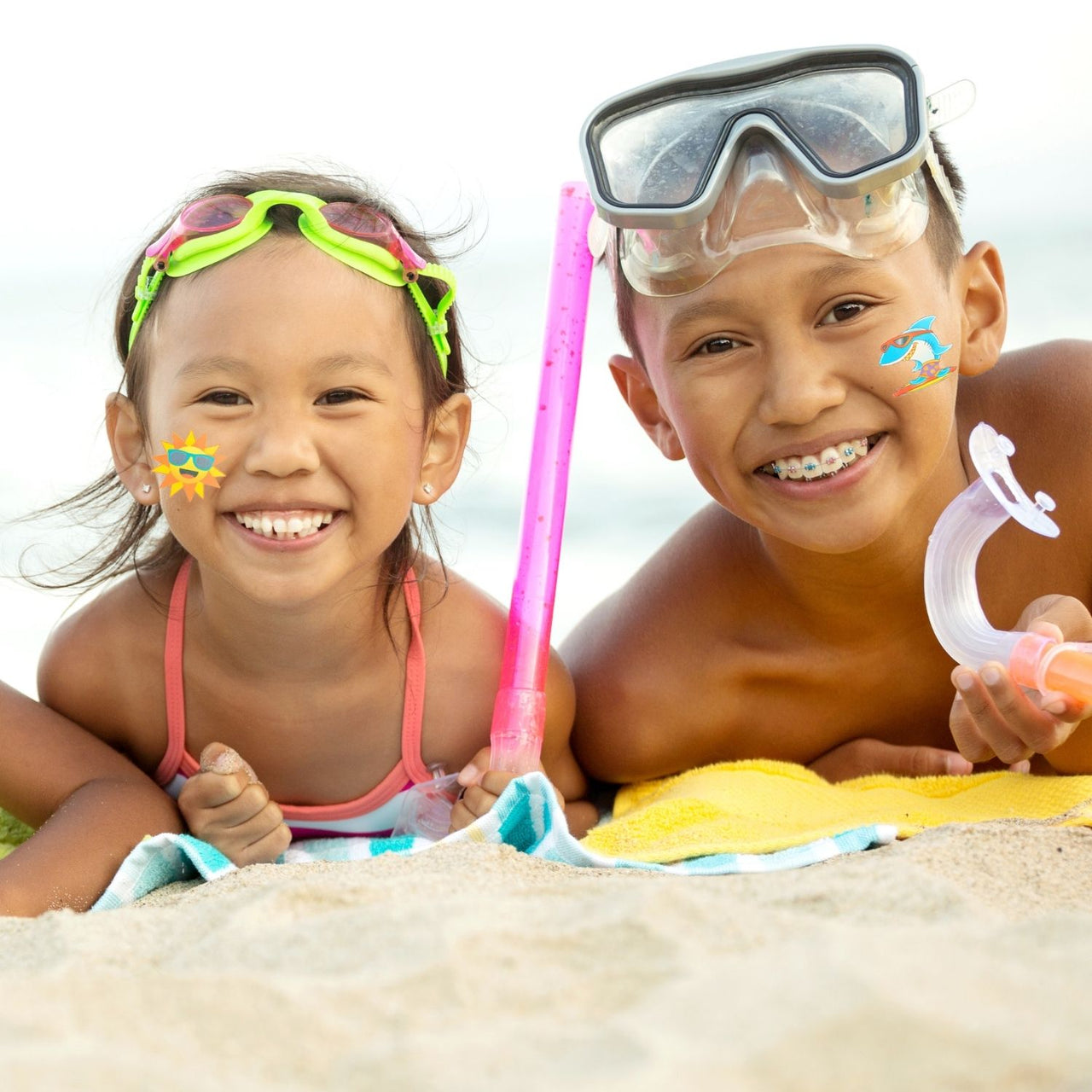 kids smiling at at the beech with tattoos