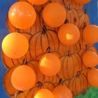 Thumbnail for orange balloons used for fall festival game