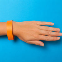 Thumbnail for orange waterproof paper wristband on arm young adult