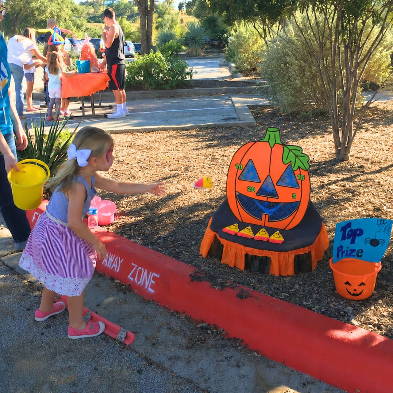 preschool girl playing fall bean bag toss