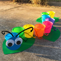 Thumbnail for brightly colored sand pails made into a caterpillar carnival game